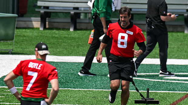 QB Aaron Rodgers pulls a weight during warmups on May 23